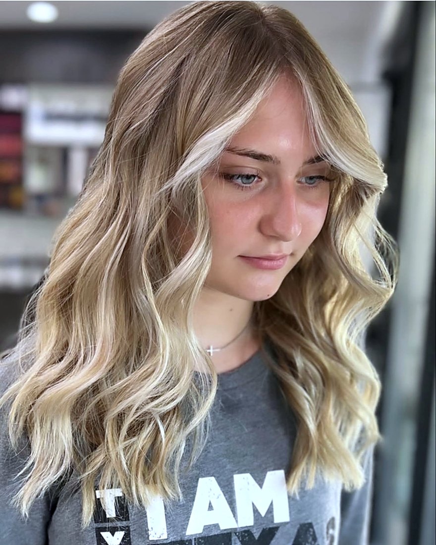 Dimensional brunette-to-blonde color and soft waves created by Meron Negasa