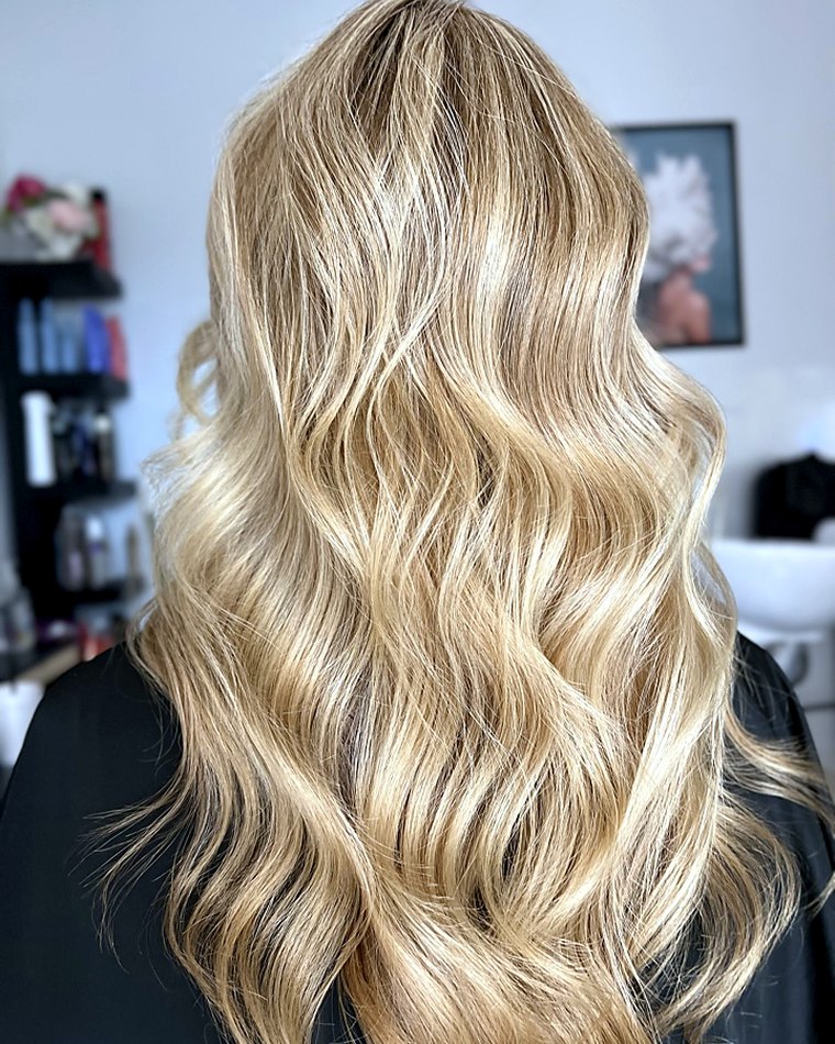 Golden blonde highlights hand-painted through soft waves